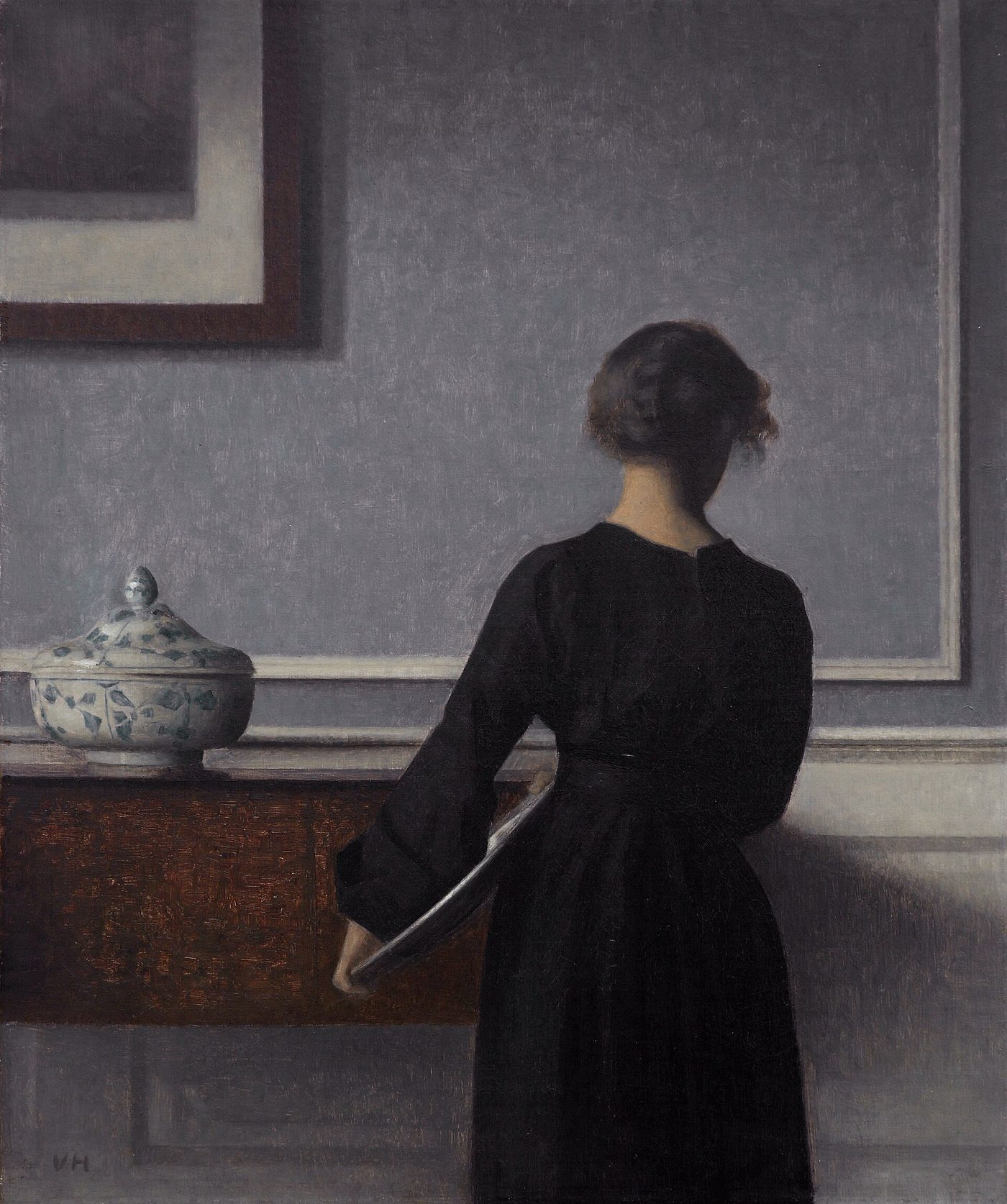 Hammershøi painting: a woman beside a mahogany chest of drawers